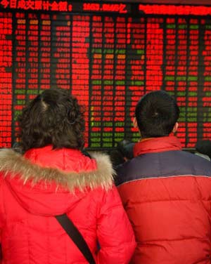 A couple look at the screen at the Shanghai Stock Exchange on Wednesday, Jan. 3, 2008. China's stock markets will have another good year in 2008, but corporate profit growth is likely to decelerate amid tightening measures, analysts said. (Xinhua Photo)